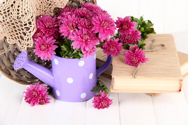 Bouquet of pink chrysanthemum in watering can on white wooden background — Stock Photo, Image