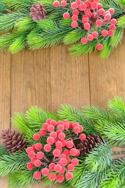 Christmas tree branches on wooden background — Stock Photo, Image