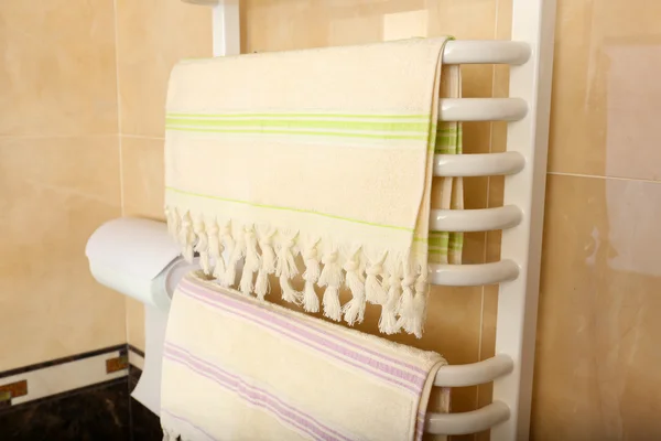 Color towels on radiator in bathroom — Stock Photo, Image