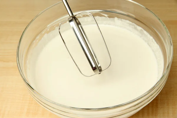 Cooking, whipping eggs with electric whisk in bowl, close up — Stock Photo, Image