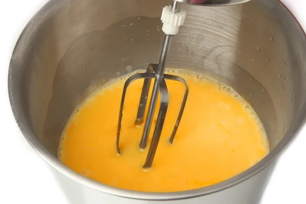 Cooking, whipping eggs with electric whisk in bowl, close up — Stock Photo, Image