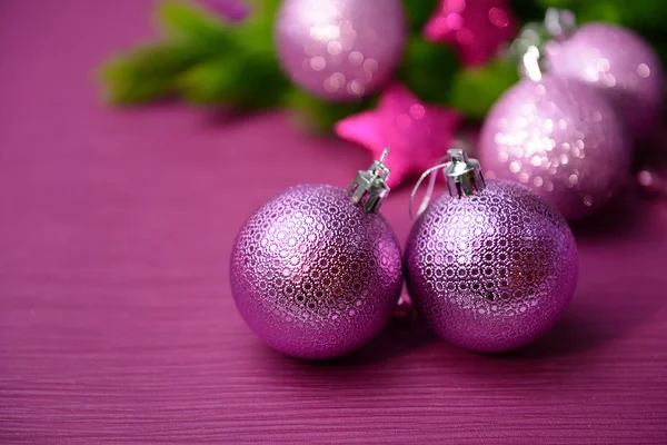 Christmas balls on fir tree, on color background — Stock Photo, Image