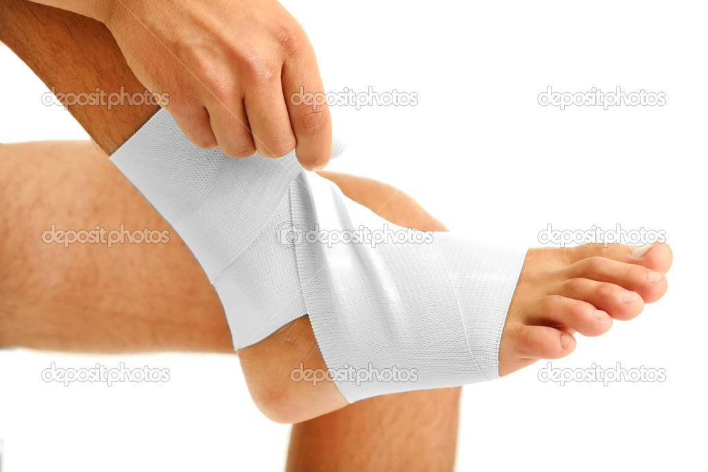Young man with elastic bandage on leg, isolated on white