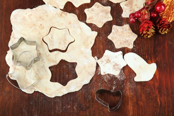 Making Christmas cookies on wooden table — Stock Photo, Image