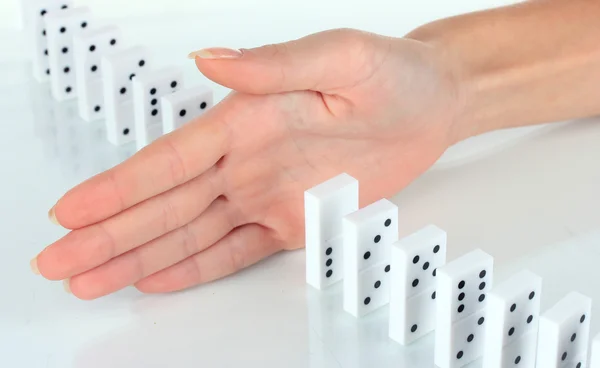Hand stopping dominoes falling — Stock Photo, Image