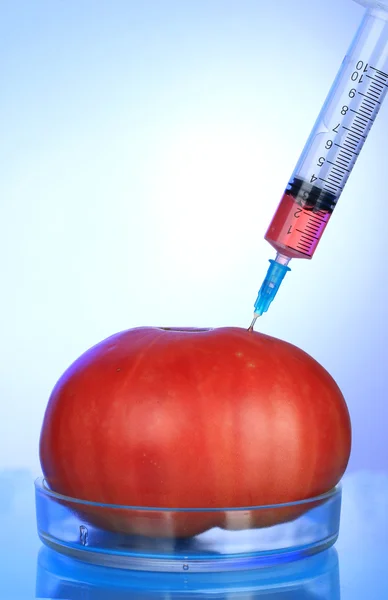 Injection into fresh red tomato — Stock Photo, Image