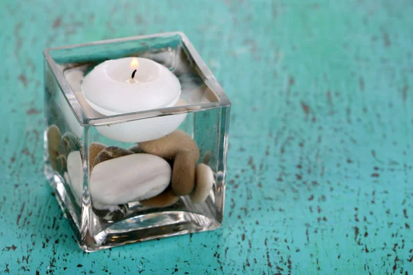 Decorative vase with candle, water and stones — Stock Photo, Image