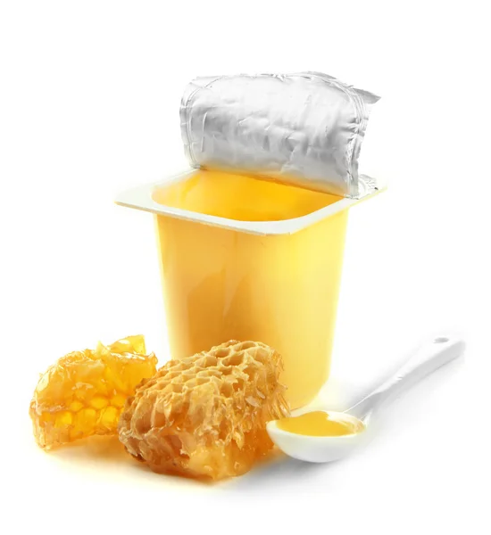 Tasty dessert in open plastic cup and honey combs, isolated on white — Stock Photo, Image