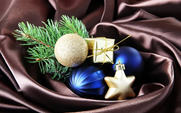 Beautiful Christmas decor on brown satin cloth — Stock Photo, Image