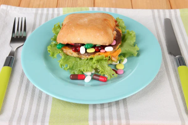 Conceptual image for nutritional care:assorted vitamins and nutritional supplements in bun. On wooden background — Stock Photo, Image