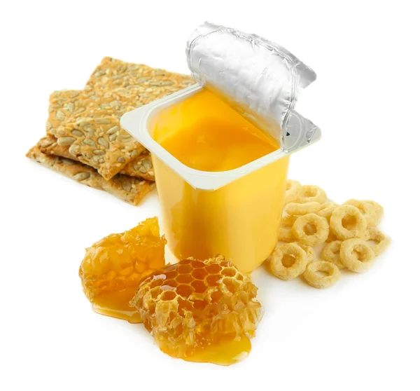 Tasty dessert in open plastic cup and honey combs, isolated on white — Stock Photo, Image