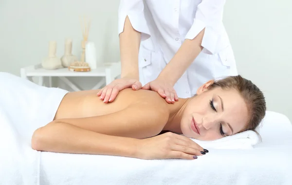 Beautiful young woman having back massage close up — Stock Photo, Image