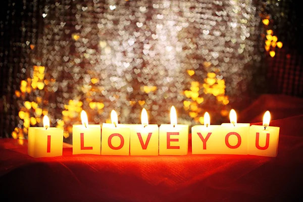 Kaarsen met afgedrukte teken die ik hou van je, op wazig lichten achtergrond — Stockfoto