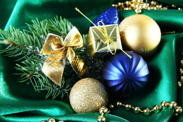 Beautiful Christmas decor on green satin cloth Royalty Free Stock Images