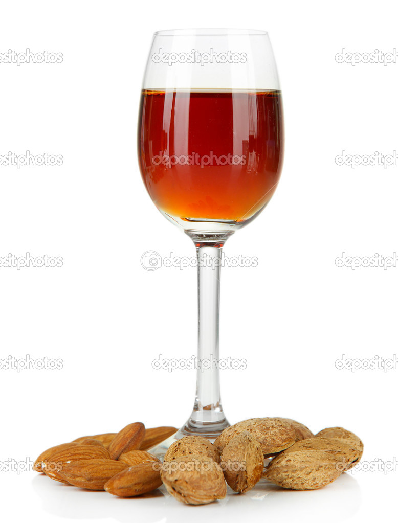 Glass of amaretto liquor and roasted almonds, isolated on white