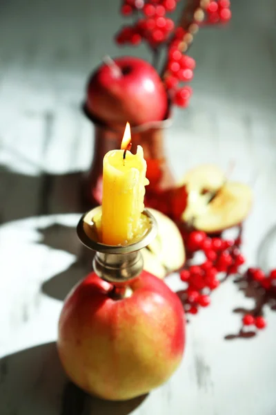 Composition with apples and candles on wooden background — Stock Photo, Image