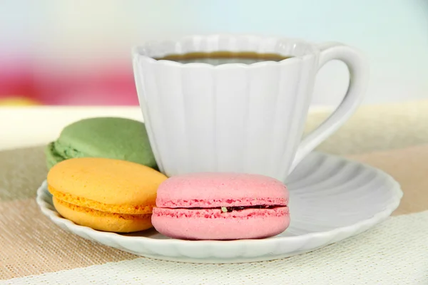 Coffee and macaroons on table on light background — Stock Photo, Image