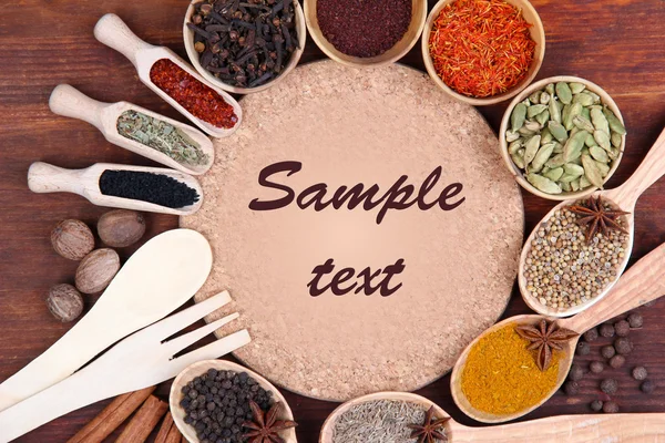 Various spices and herbs with empty board — Stock Photo, Image