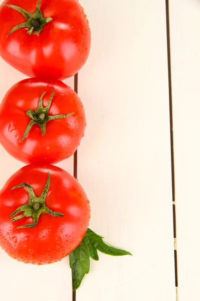 Tomates frescos sobre fundo de madeira branca — Fotografia de Stock