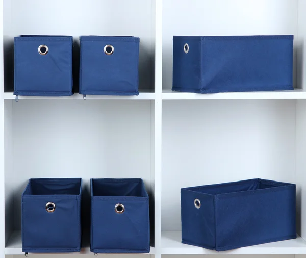 Blue textile boxes in white shelves — Stock Photo, Image