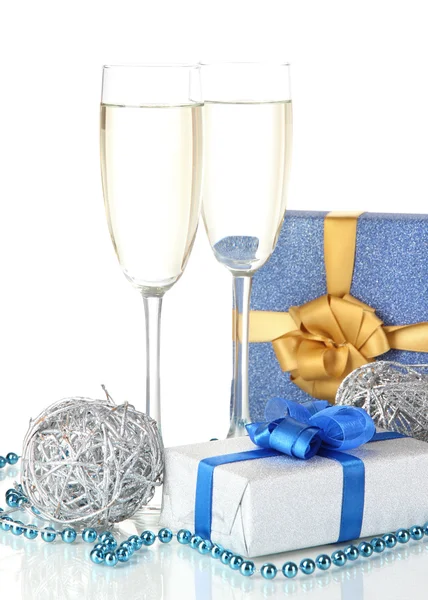 Glasses of champagne with gift boxes isolated on white — Stock Photo, Image