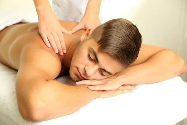 Young man having back massage close up — Stock Photo, Image