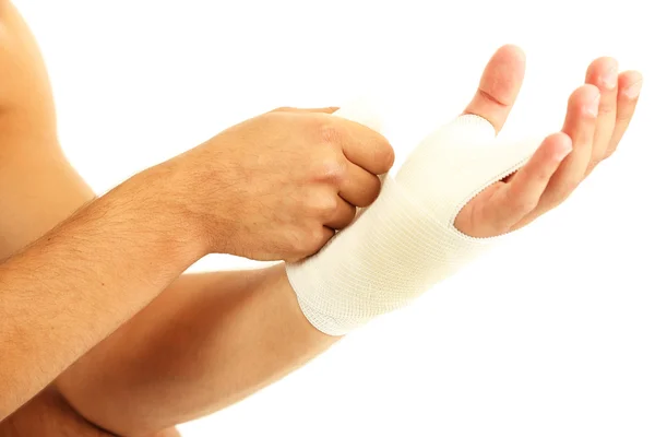 Jovem com bandagem elástica na mão, isolado em branco — Fotografia de Stock