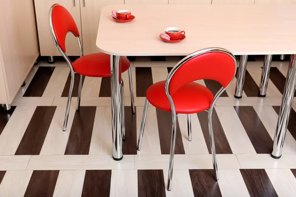 Moderní červené židle u stolu v kuchyni — Stock fotografie