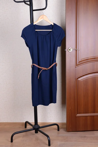 Dress hanging on hanger near door — Stock Photo, Image