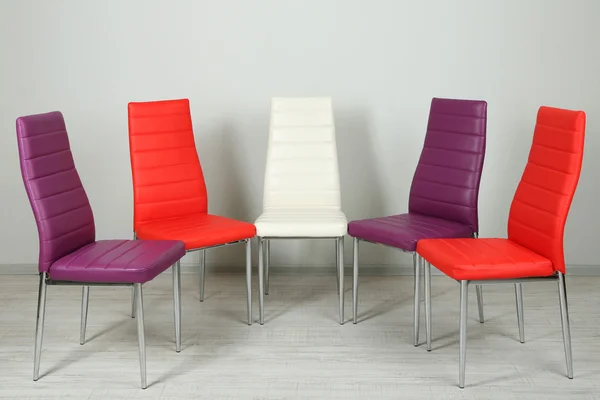 Modern color chairs on wall background — Stock Photo, Image