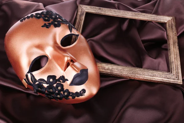 Mask on brown fabric background — Stock Photo, Image