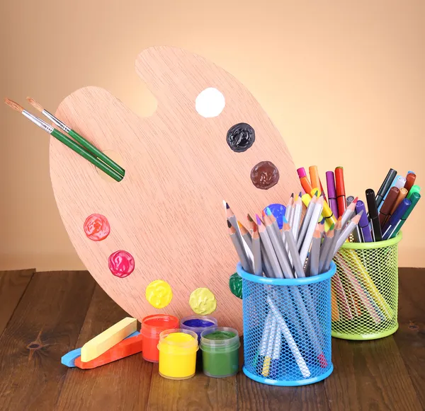 Composition of various creative tools on table on beige background — Stock Photo, Image