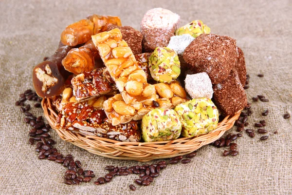 Tasty oriental sweets, on burlap background — Stock Photo, Image