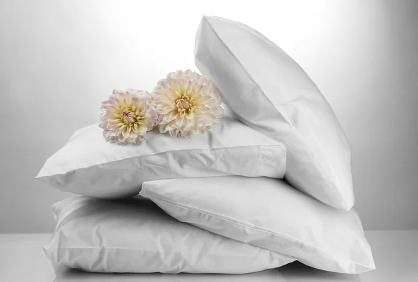 Pillows and flowers, on grey background — Stock Photo, Image