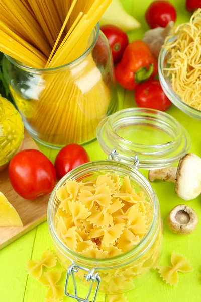 Pasta with oil, cheese and vegetables on wooden table close-up — Stock Photo, Image