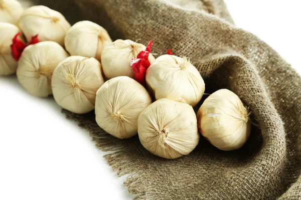 Vintage garlic and pepper decoration, on sackcloth, isolated on white — Stock Photo, Image