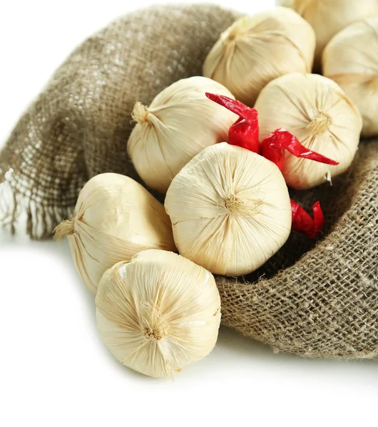 Vintage garlic and pepper decoration, on sackcloth, isolated on white — Stock Photo, Image