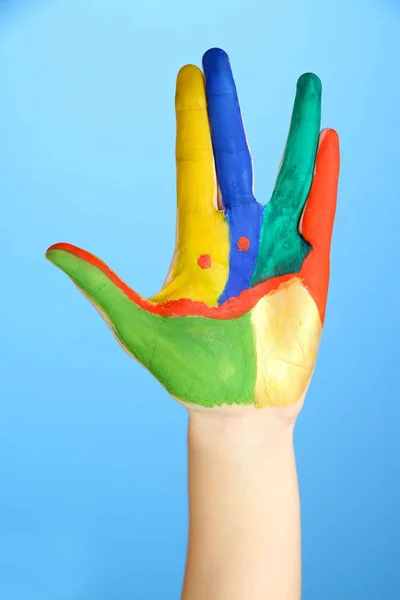 Painted hand with smile on blue background — Stock Photo, Image