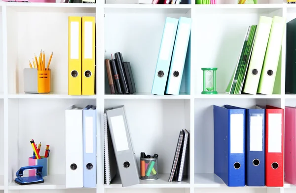 White office shelves with folders and different stationery, close up — Stock Photo, Image