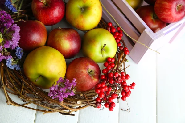 Juicy apples in box on white wooden table — Stock Photo, Image