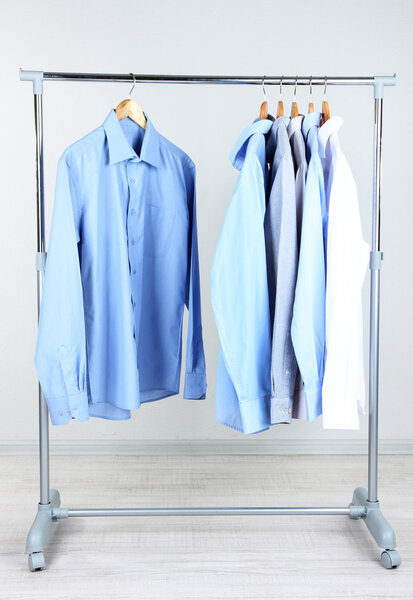 Office male clothes on hangers, on gray background