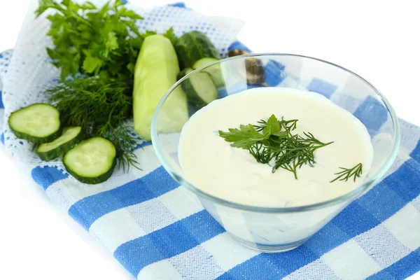 Komkommer yoghurt in glazen kom, op kleur servet, geïsoleerd op wit — Stockfoto