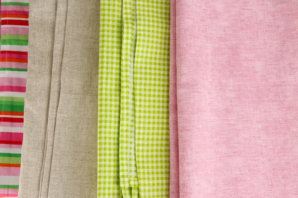 Pile of different fabrics close-up background — Stock Photo, Image