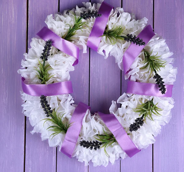 Decorative wreath with flowers on wooden background — Stock Photo, Image