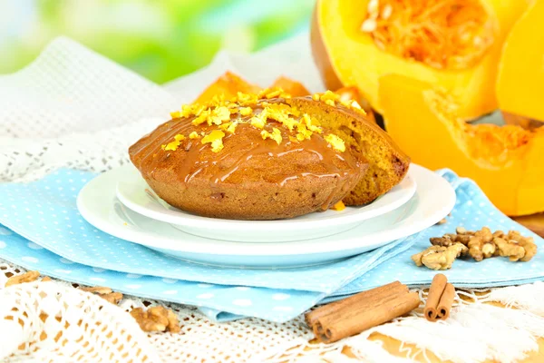 Delicious pumpkin pie on plate on wooden table on natural background — Stock Photo, Image