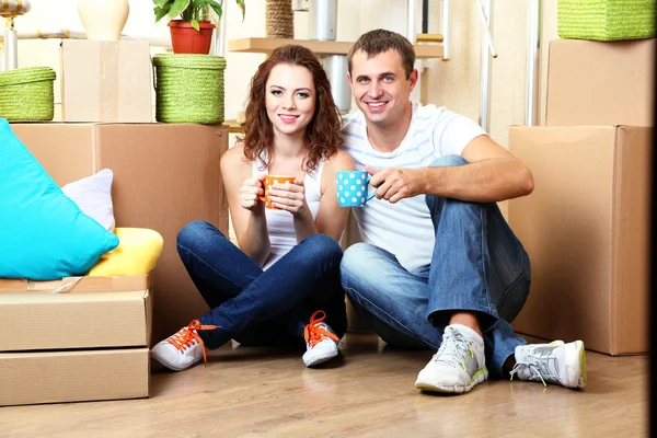 Pareja joven celebrando mudarse a un nuevo hogar — Foto de Stock