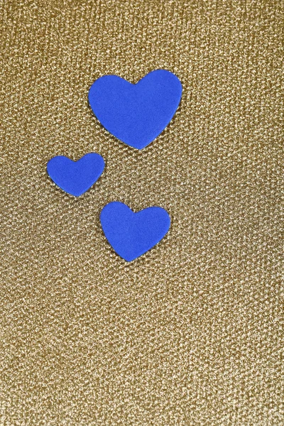 Blue hearts made of felt on golden background — Stock Photo, Image