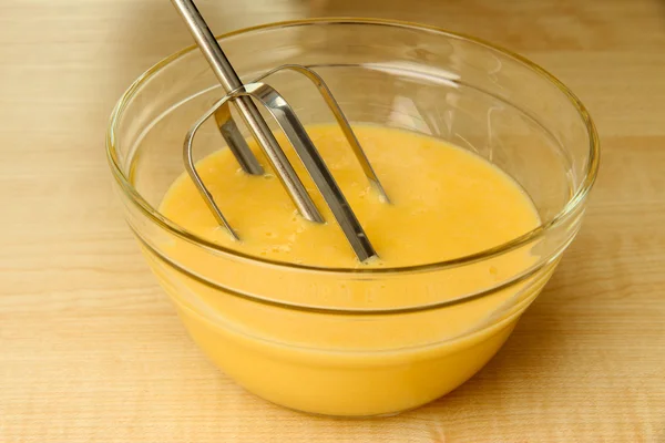 Cooking, whipping eggs with electric whisk in bowl, close up — Stock Photo, Image