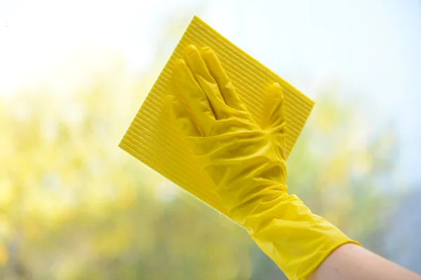 Hands with napkin cleaning window — Stock Photo, Image