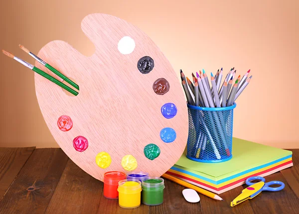 Composition of various creative tools on table on beige background — Stock Photo, Image